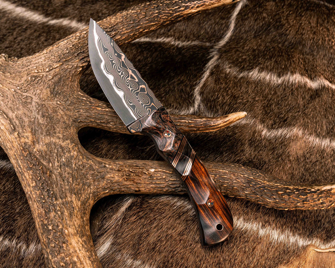 Cavner- Baker Forge CopperMai Raindrop Ni Shim- Copper Dark Matter Carbon, Black G10 and Copper Pin Striping, Copper Dark Matter Carbon Split, Desert Ironwood, Copper Patriot Mosaic Pins, Copper Lanyard Pin, Textured Grip