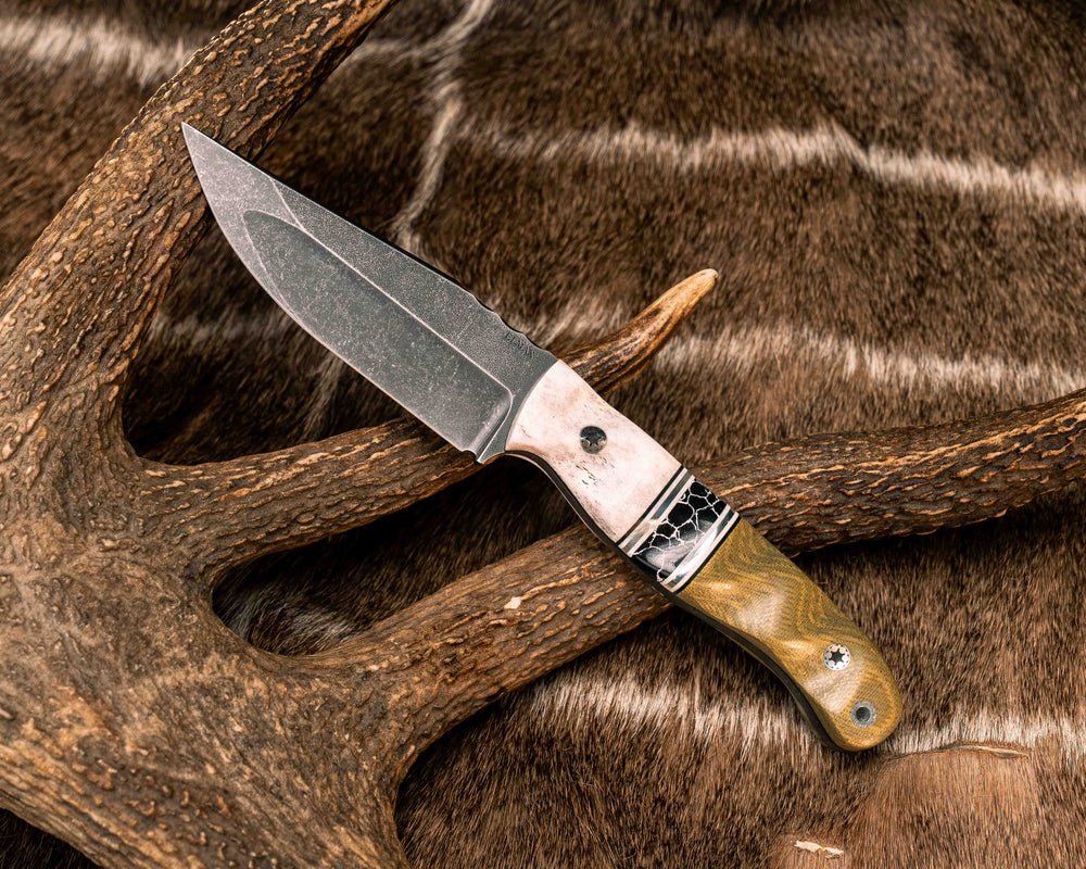Crow Jr (Compound Grind)- Elk Antler, Black G10, White G10 and Aluminum Pin Striping, Black with White Web Tru-stone Split, Olive Green Canvas Micarta, Mosaic Pins, Aluminum Lanyard Pin, Textured Grip