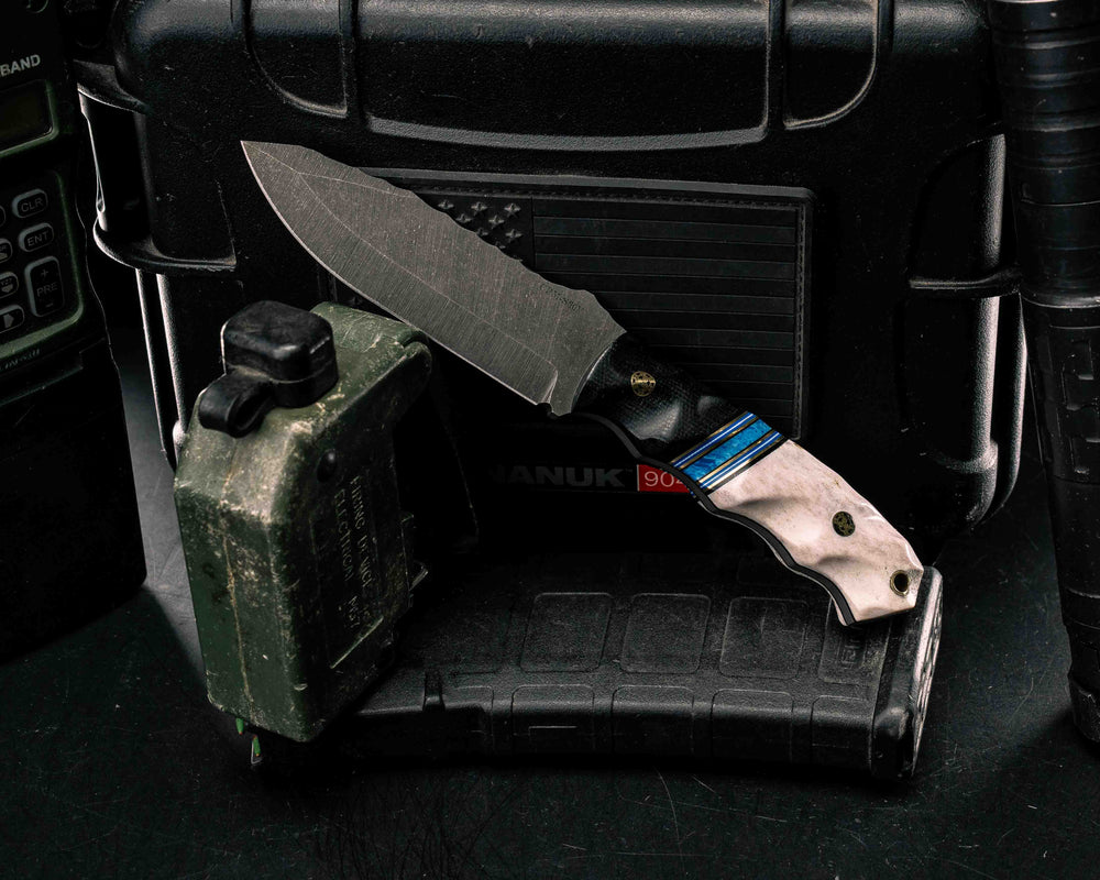 Disaster Jr- Black Canvas Micarta, Black G10, Brass, Blue G10 and White G10 Pin Striping, Dark Denim Lapis Recon Stone Split, Elk Antler, Brass Mosaic Pins, Brass Lanyard Pin, Textured Grip