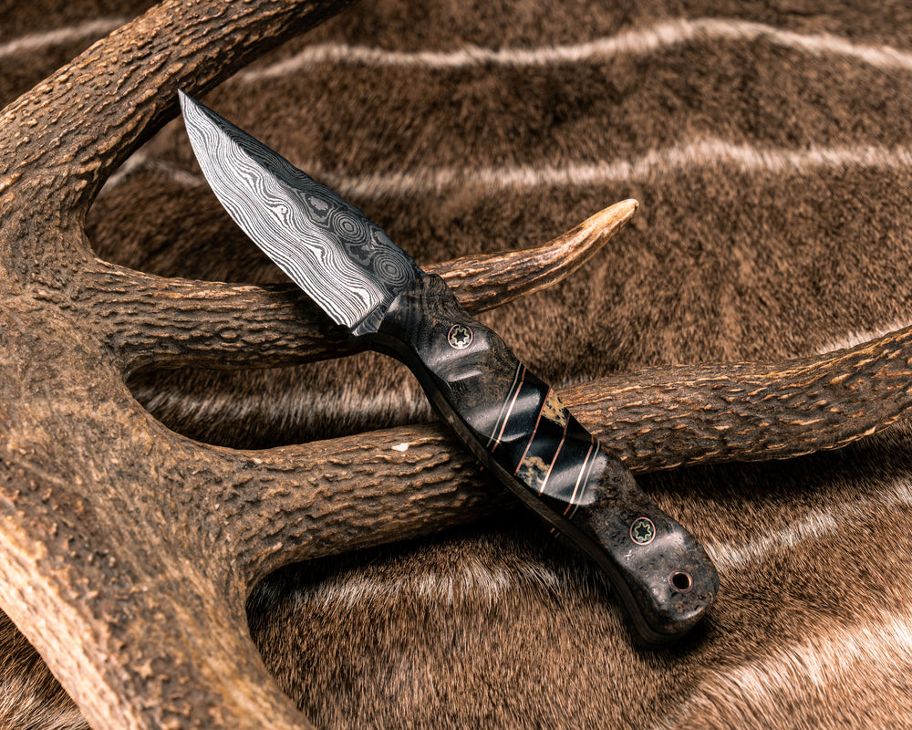 Cowboy Carry- Baker Forge Raindrop Damascus- Dyed Black Ash, Black G10, Tan G10 and Copper Pin Striping, Black Canvas Micarta and Blue Raffir Split, Mosaic Pins, Copper Lanyard Pin, Textured Grip