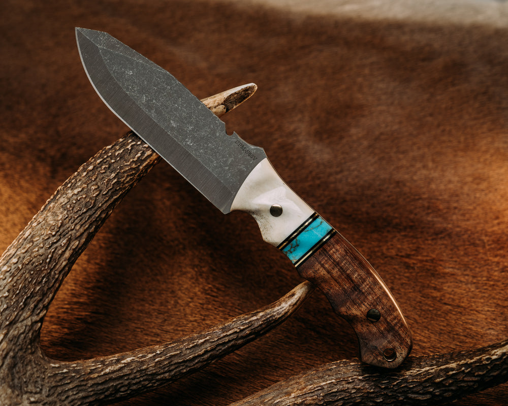 Notched Disaster Breacher - Elk Antler, Black G10 & Brass Pin Striping, Turquoise w/ Gold Web Tru Stone Split, Hawaiian Curly Koa, Brass Pins, Textured Grip.