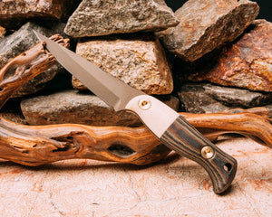 Congressman- Camel bone, camocanvas micarta, midnight bronze cerakote, brass allen bolts, smooth grip