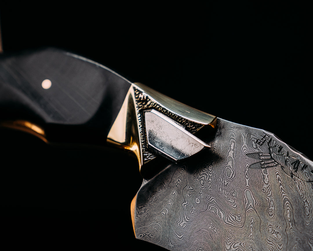 Half Face Blades X Dire Pacific Giveaway - Recurve Fighter - 400 Layered Dire Pacific Forged Damascus - Brass Bolster w/ Crystallized Titanium Guard Inlay, African Blackwood, Solid Brass Pommel, Crystalized Titanium Pommel Cap, Bronze Pins, Textured Grip.